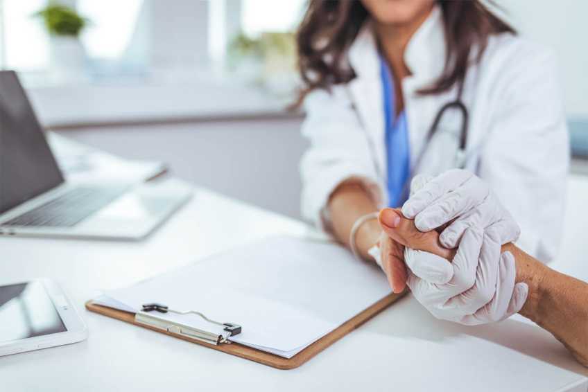 A nurse comforting a patient during treatment